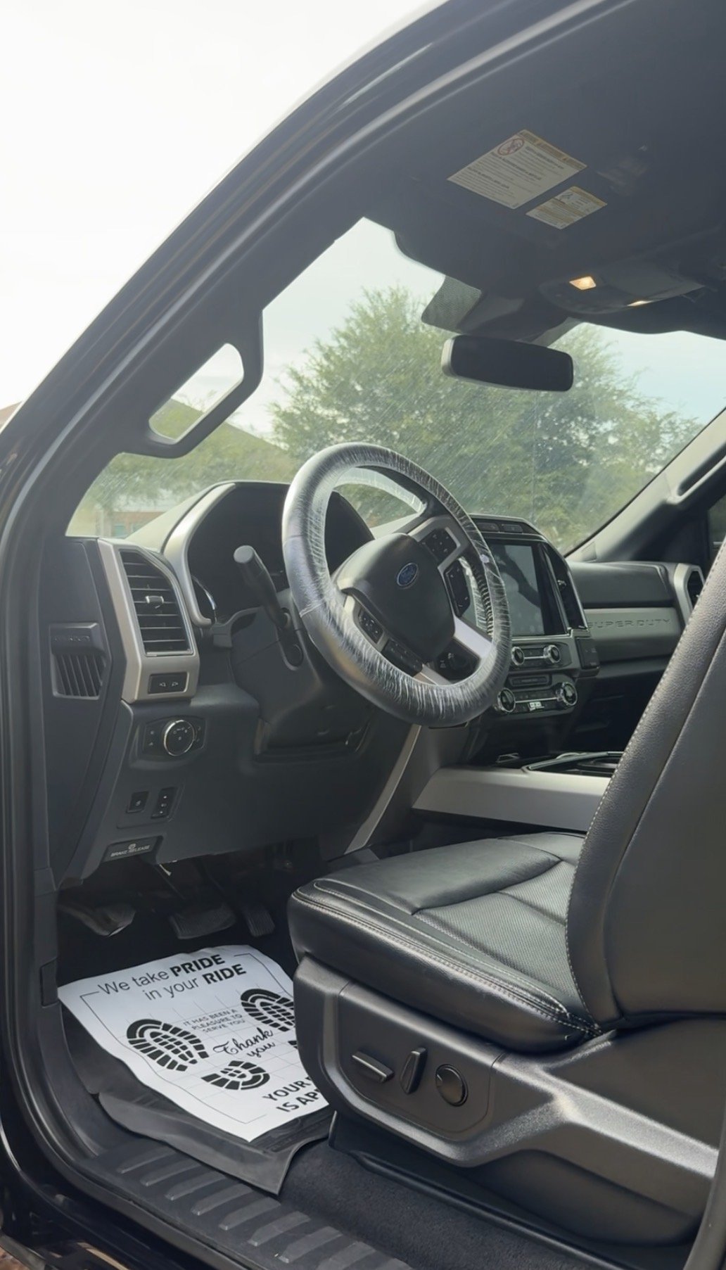 Interior of freshly detailed Ford Super Duty — steering wheel, dashboard and leather seats
